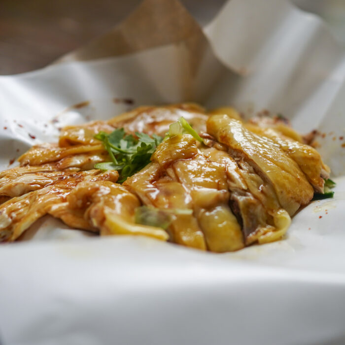 Kampong chicken rice dish at Nat's Chicks, featuring succulent chicken and fragrant rice.