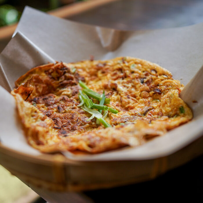 Chai Po omelette, a popular menu item at Nat's Chicks, featuring beaten eggs with preserved radish.