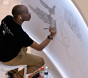 Renowned artist Stephen Wiltshire drawing a detailed panorama of Singapore’s skyline at Singapore City Gallery.