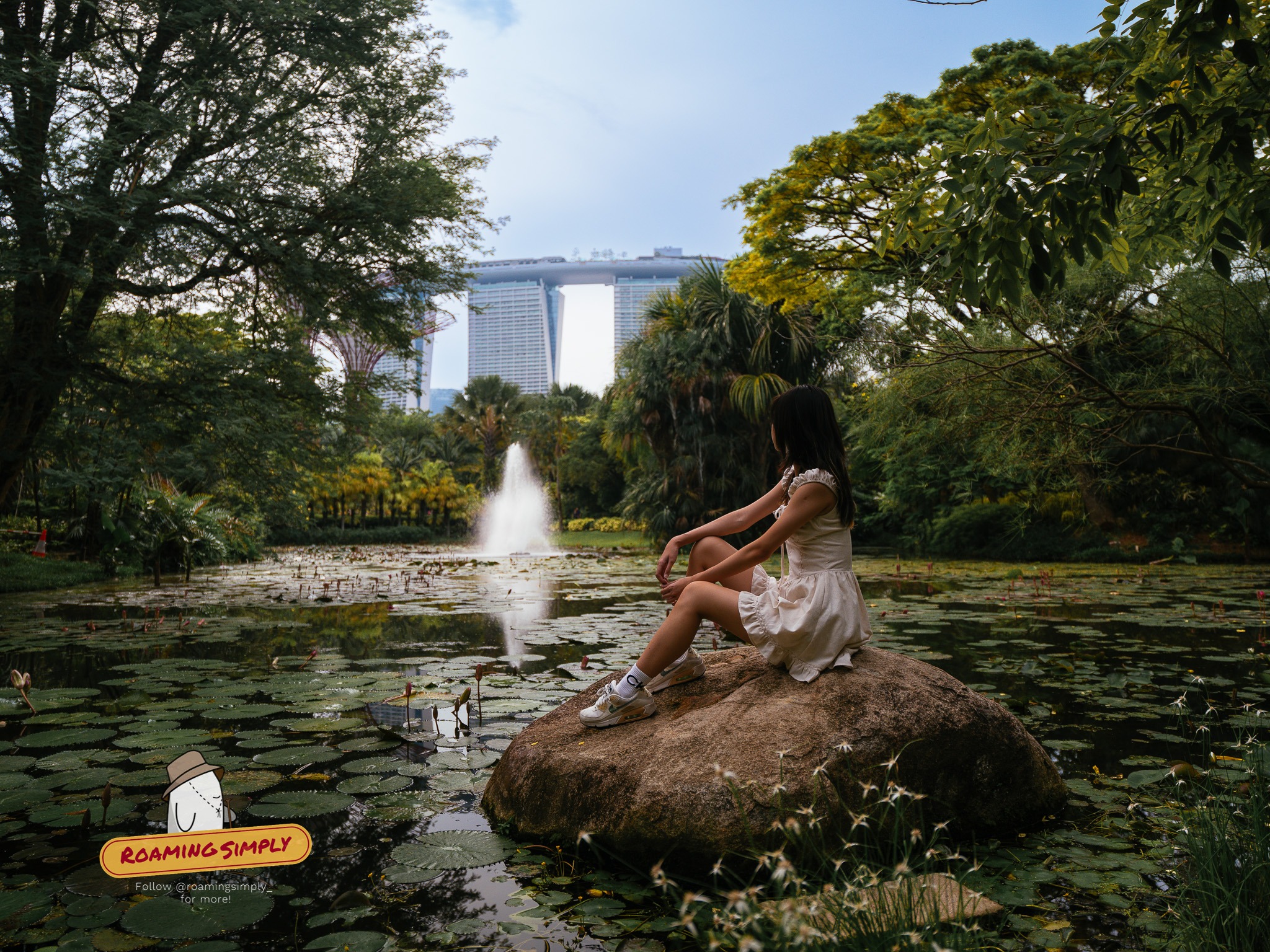 Girl at gardens by the bay with marina bay sands at the backgroud