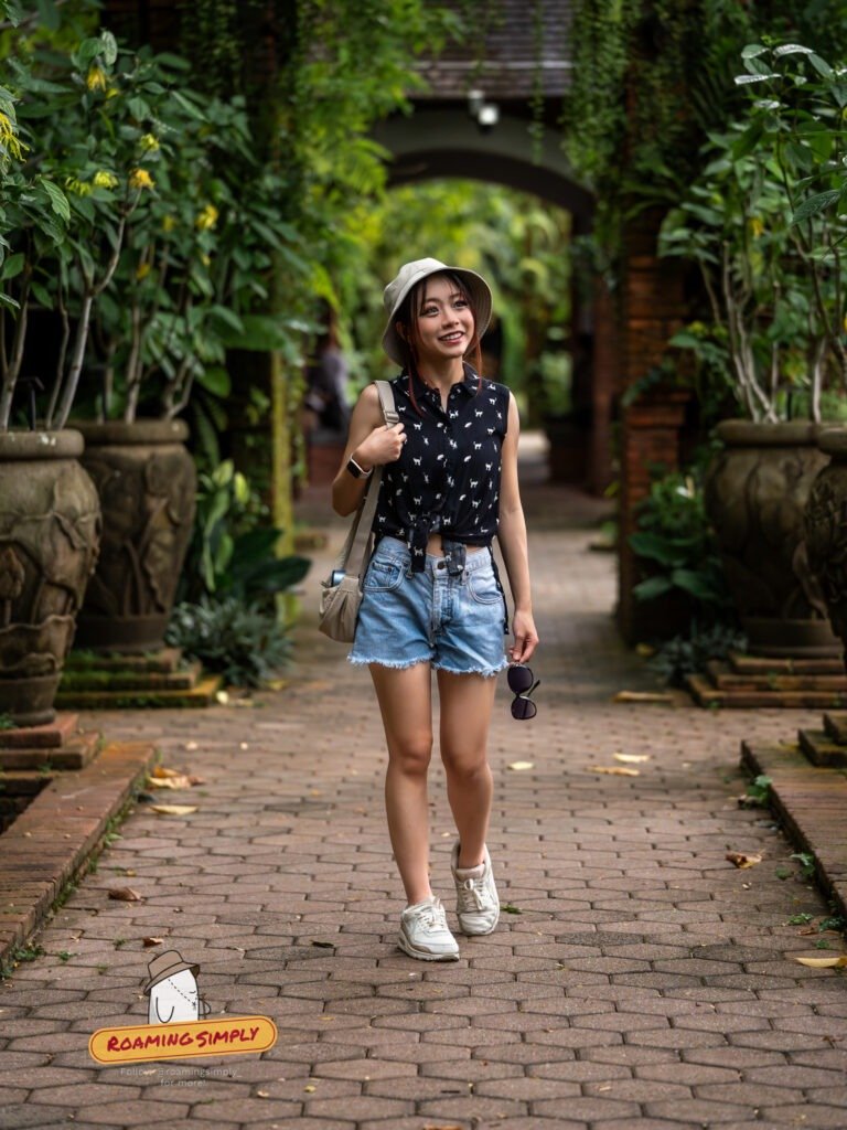 Walker on a brick path under a garden archway