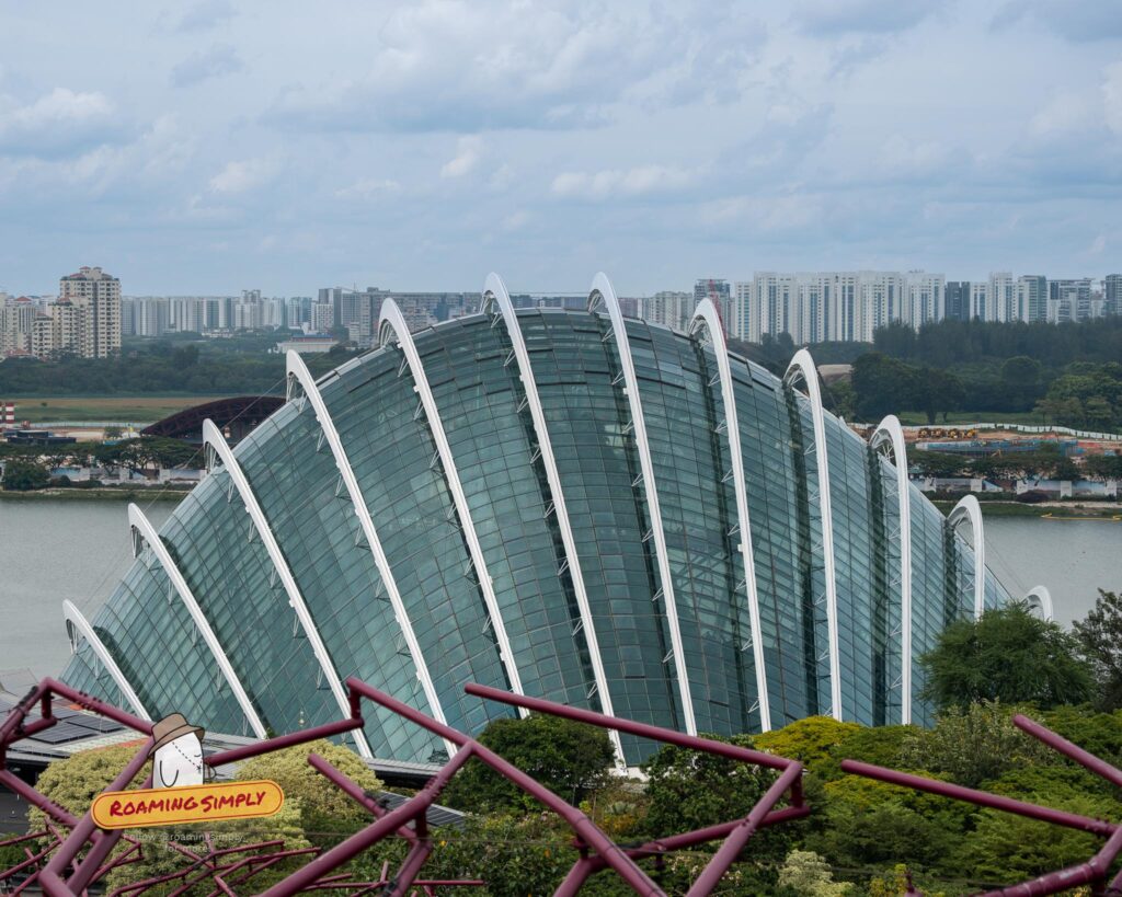 Exterior view of the massive glass Cloud Forest conservatory dome with its curved white steel arches at Gardens by the Bay, Singapore.
