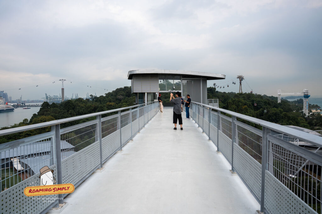 Visitors photographing panoramic views of Sentosa harbour and cable cars from Fort Siloso Skywalk Singapore