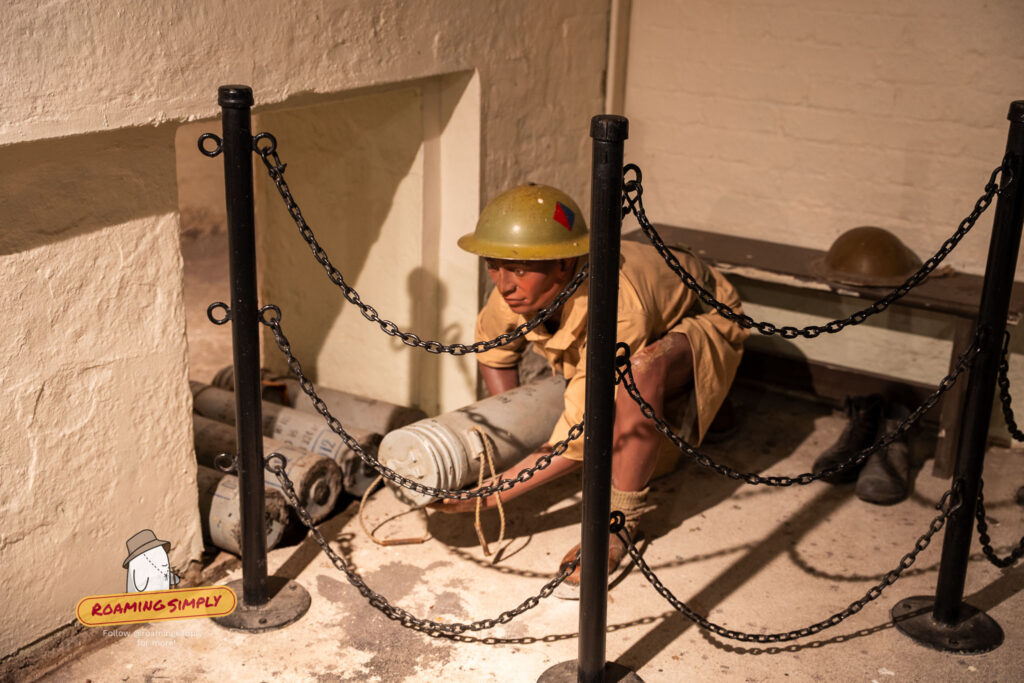 Realistic waxwork figure of WWII British soldier handling ammunition inside Fort Siloso bunker Sentosa Singapor