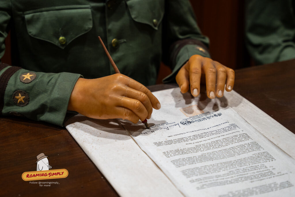 Close-up waxwork of Japanese officer signing WWII surrender document at Fort Siloso Surrender Chambers Sentosa