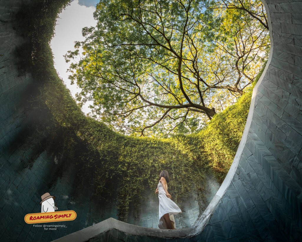 Woman in a white dress on the spiral staircase of the Fort Canning Park Tree Tunnel under the tree canopy