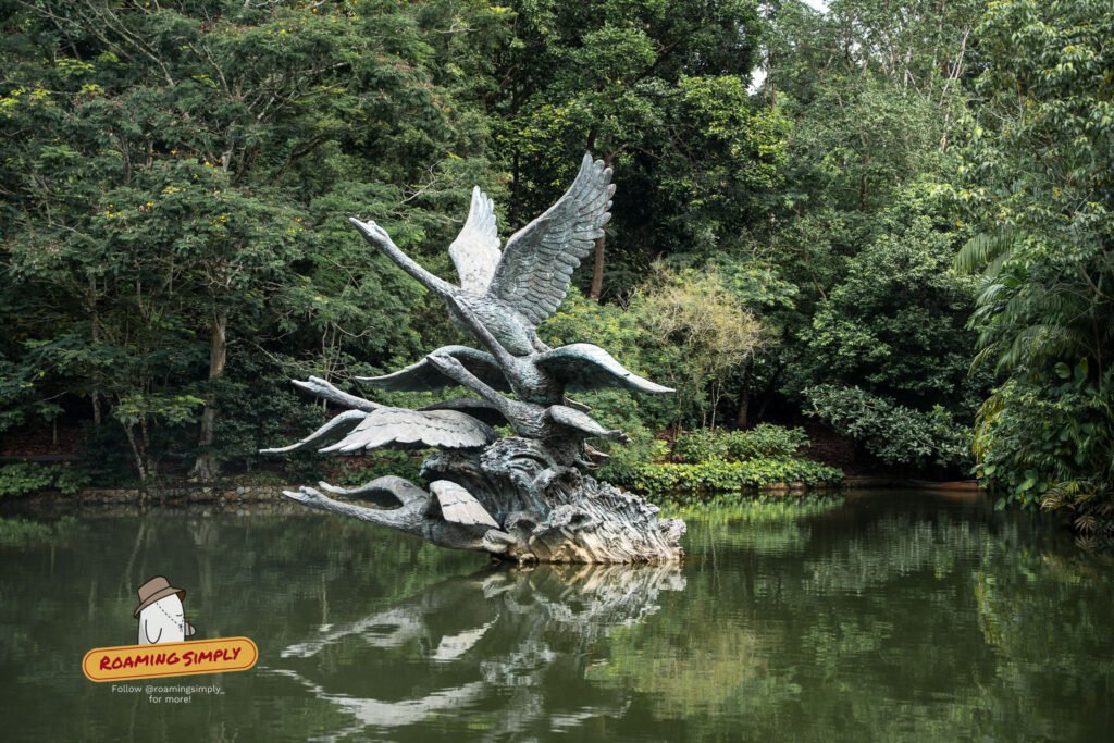 Flight of Swans, a bronze sculpture by Eng Siak Loy, beside the water at Swan Lake, Singapore Botanic Gardens.