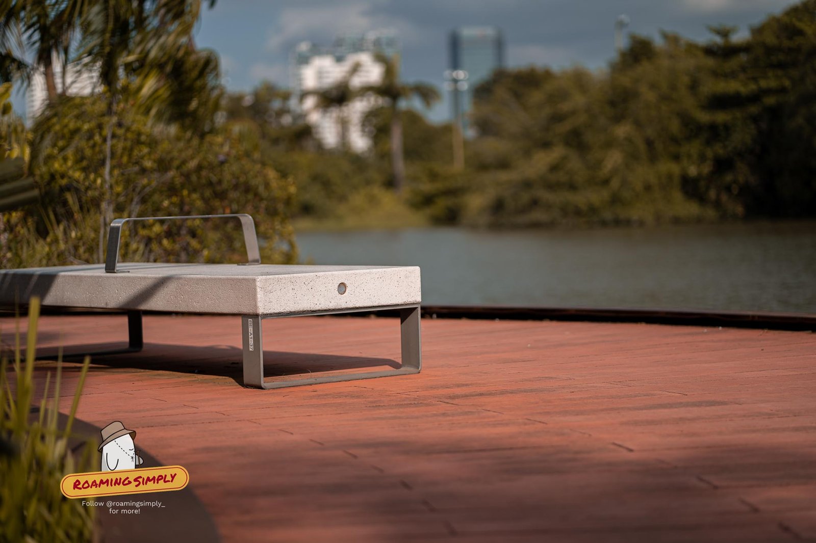 Bench on the lakeside boardwalk with panoramic views over Jurong Lake, Singapore