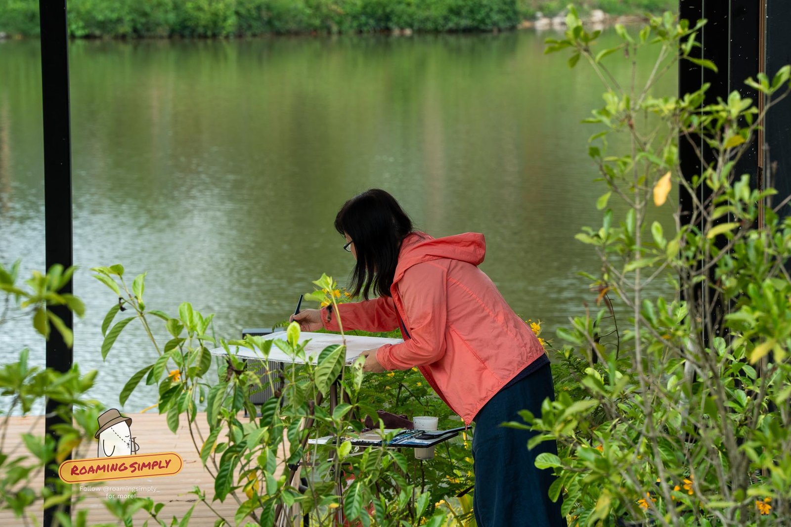 A visitor sketching by the lake at Jurong Lake Gardens, Singapore