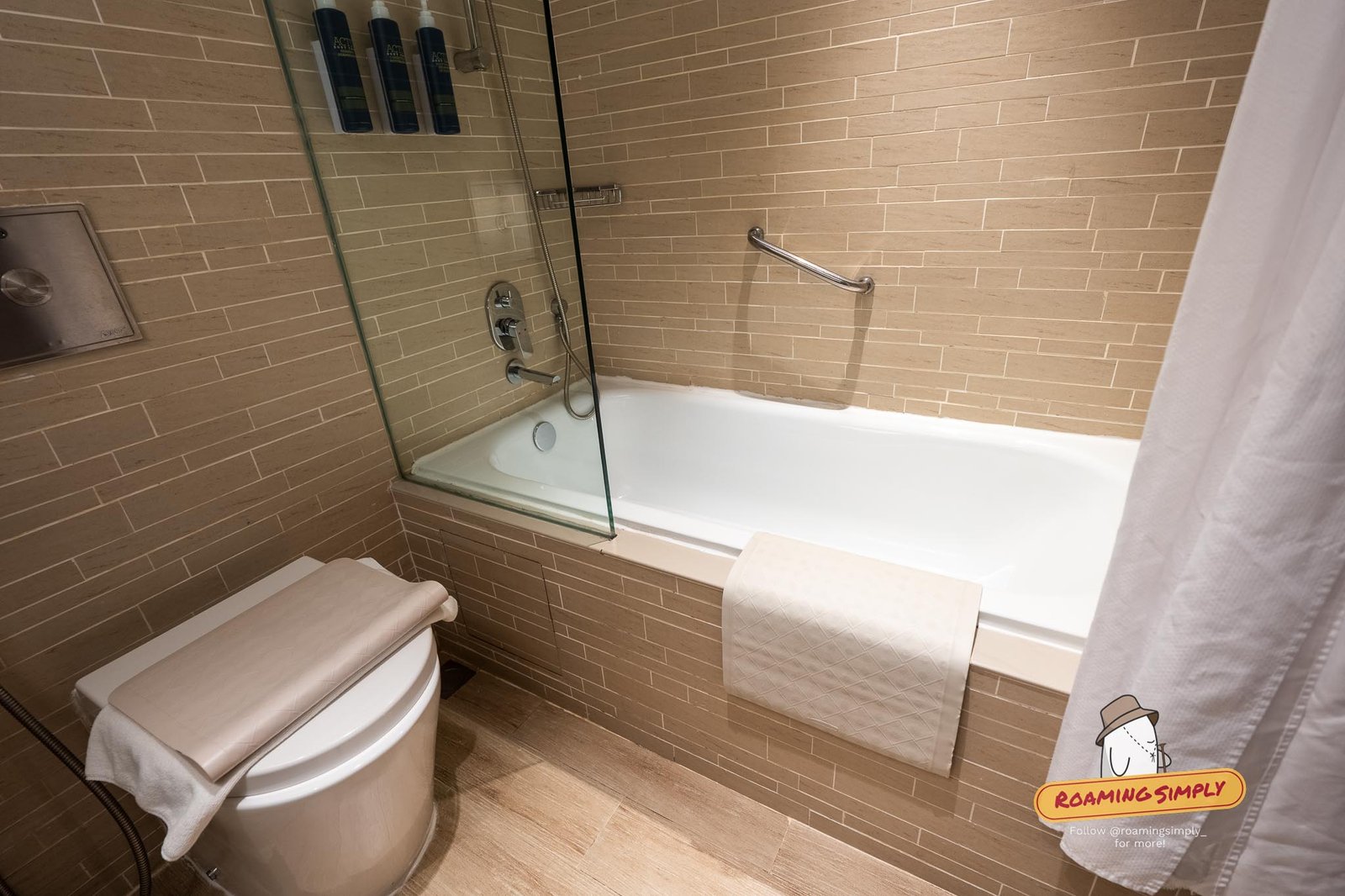 Full tub-and-shower combination in the Deluxe Room bathroom