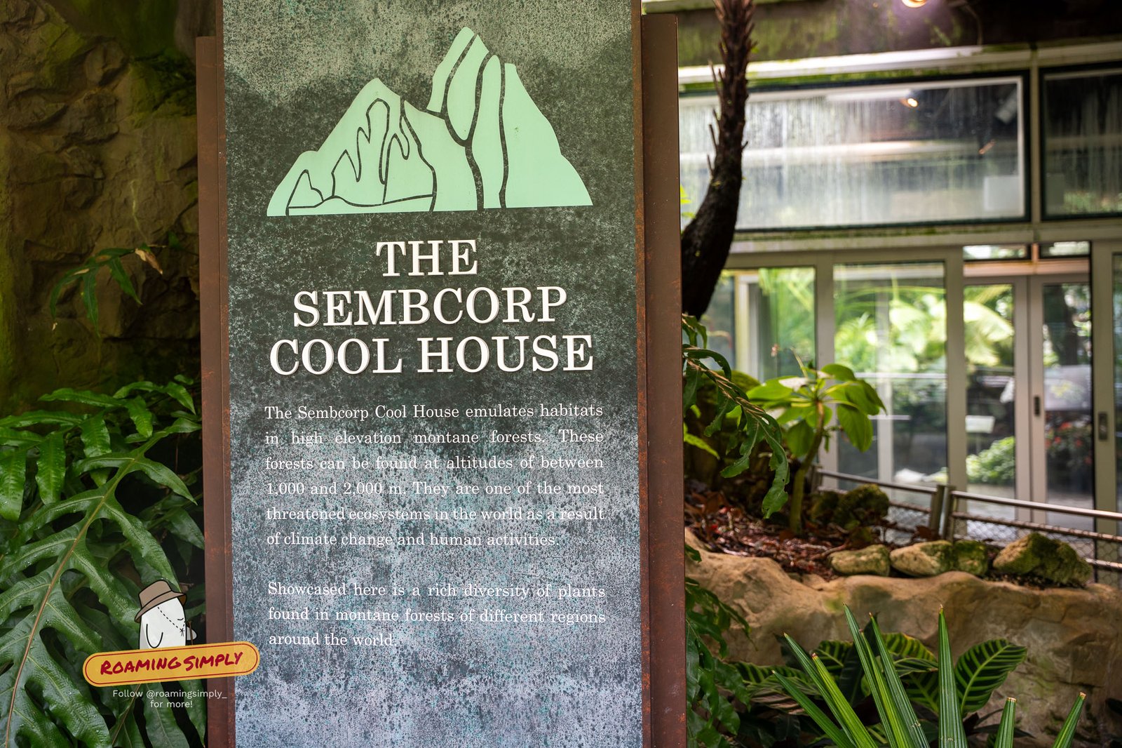 Entrance sign for the Sembcorp Cool House at the National Orchid Garden, with the misty glasshouse behind