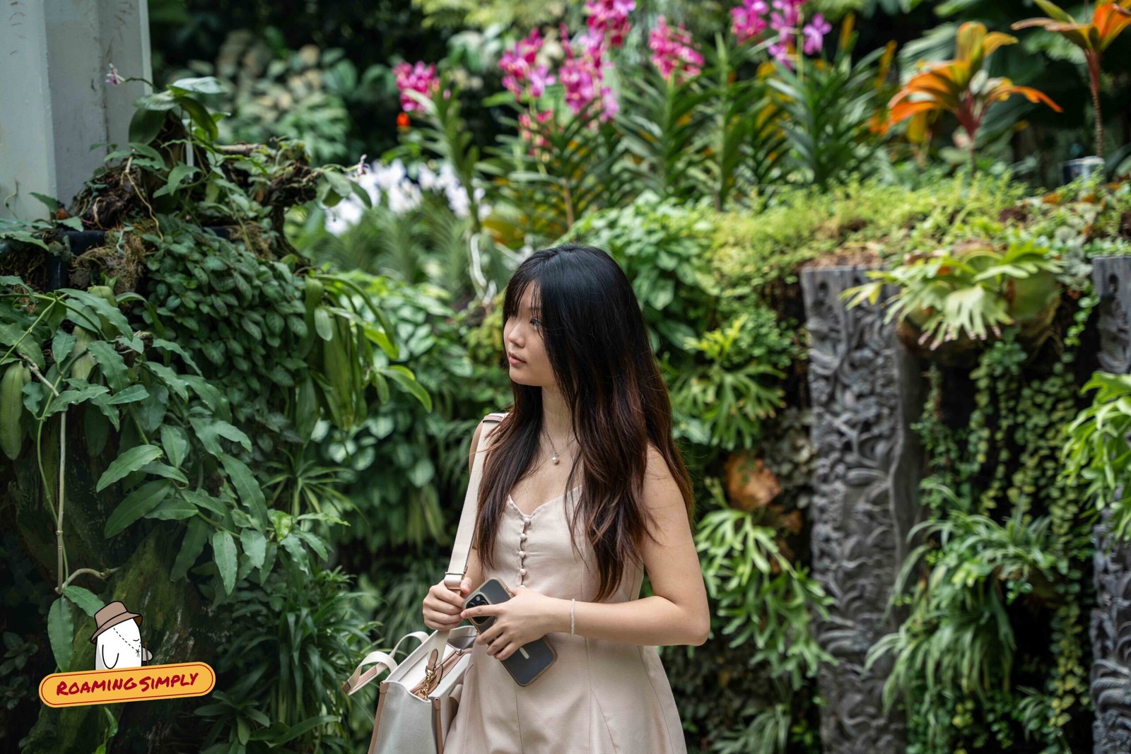 A visitor among orchids and staghorn ferns in the Tan Hoon Siang Mist House at the National Orchid Garden, Singapore