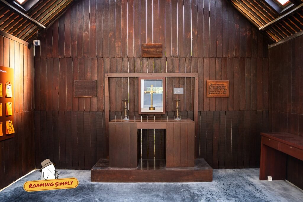 Wooden altar and cross inside the chapel at Changi Chapel and Museum, Singapore